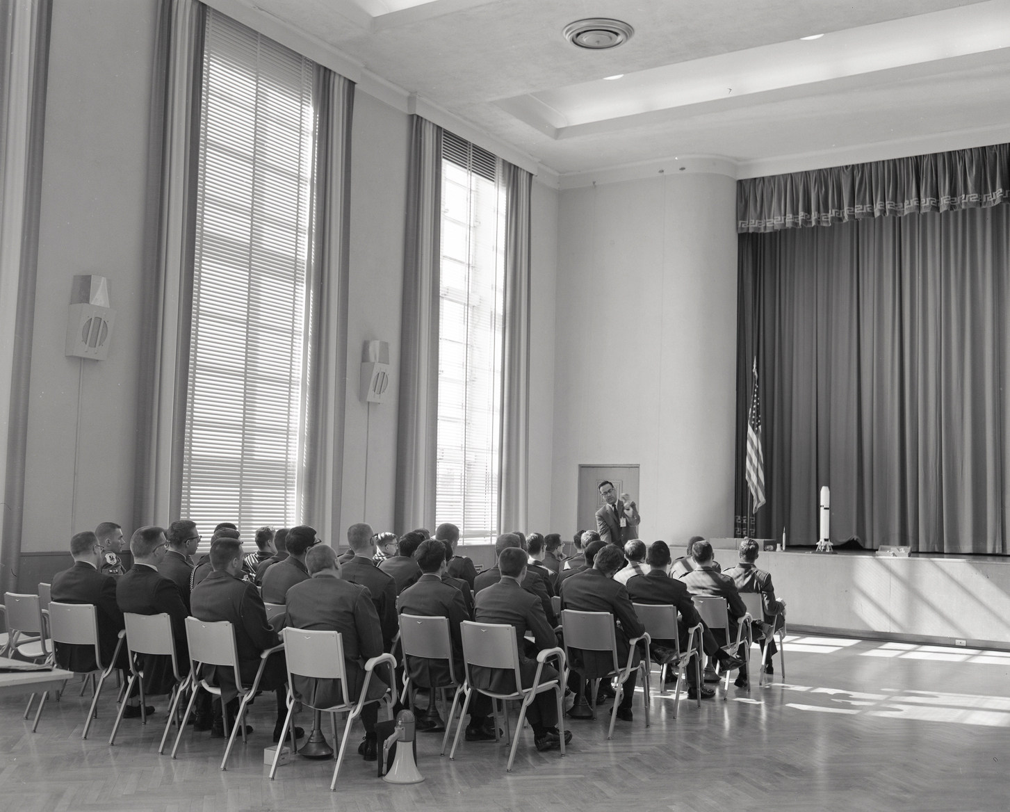 People seated in rows in auditorium.