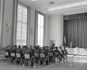 People seated in rows in auditorium.