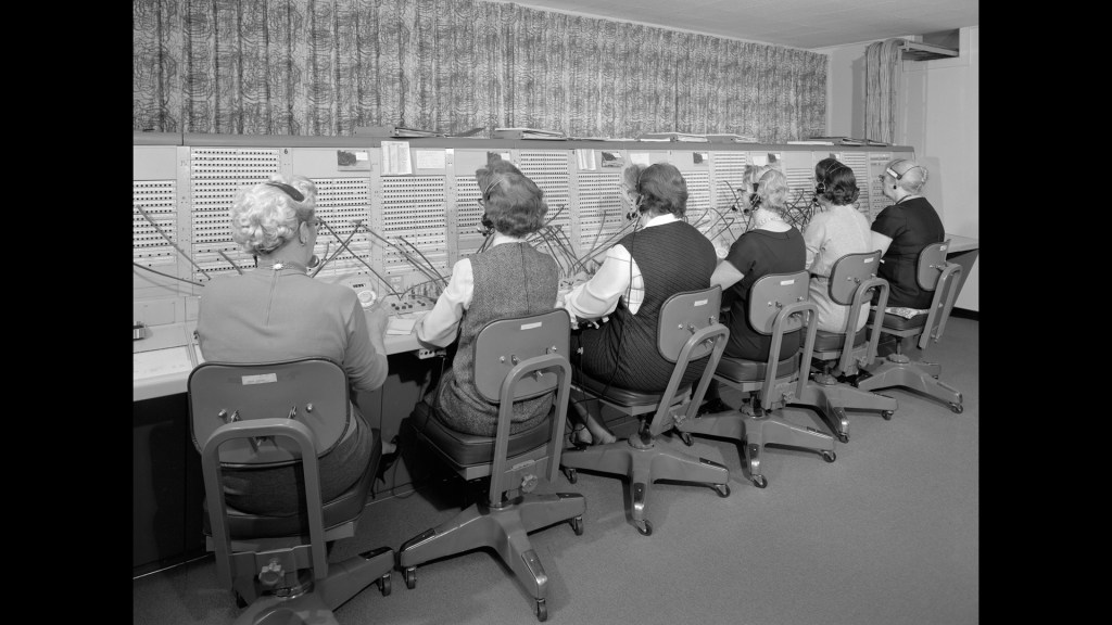 Six women sitting at switchboard.
