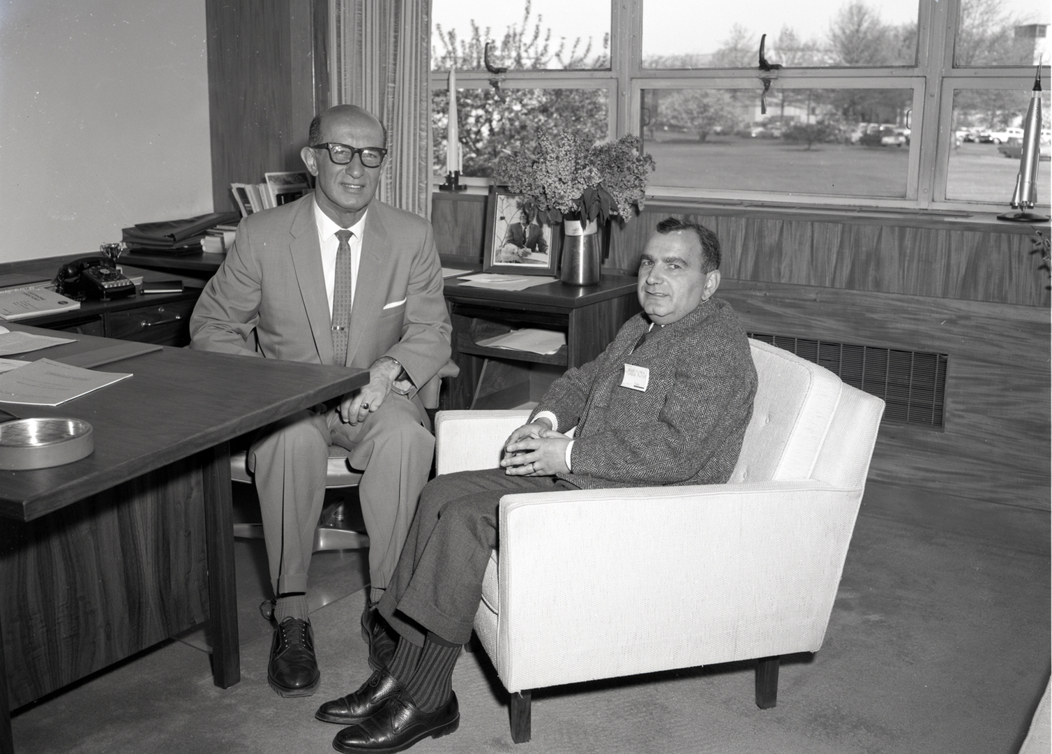 Two men sitting in office.
