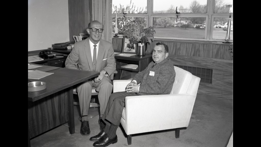 Two men sitting in office.