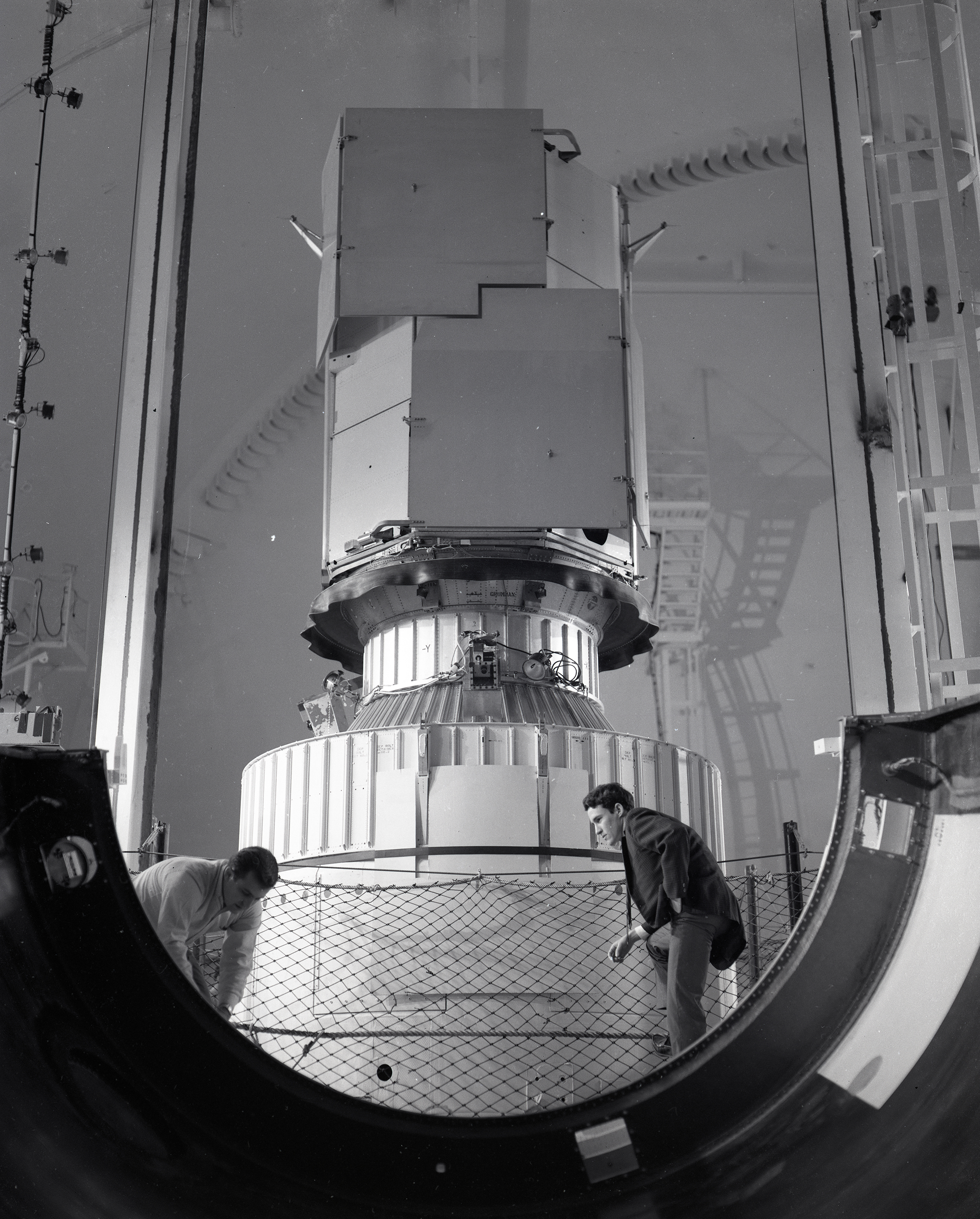 Lewis researchers examine the base of the OAO-2 nose fairing after it was jettisoned in SPC No. 2