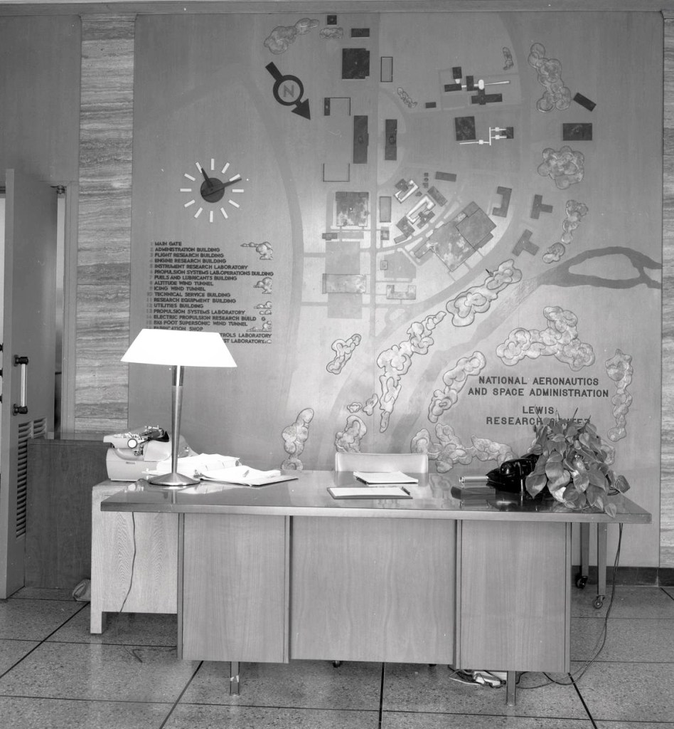 Desk with wall map behind.