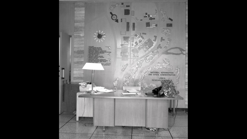 Desk with wall map behind.