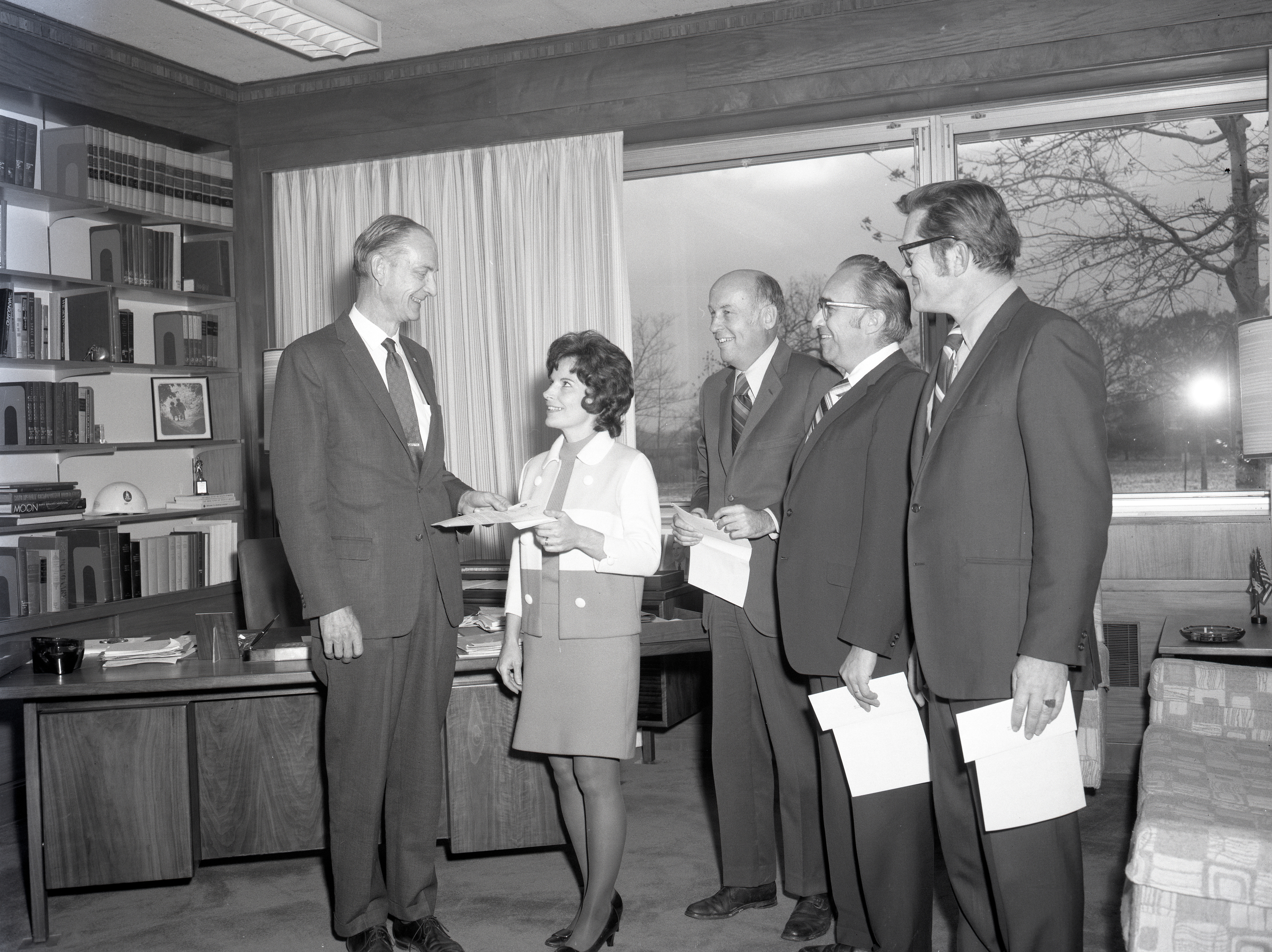 Group of people standing in office.