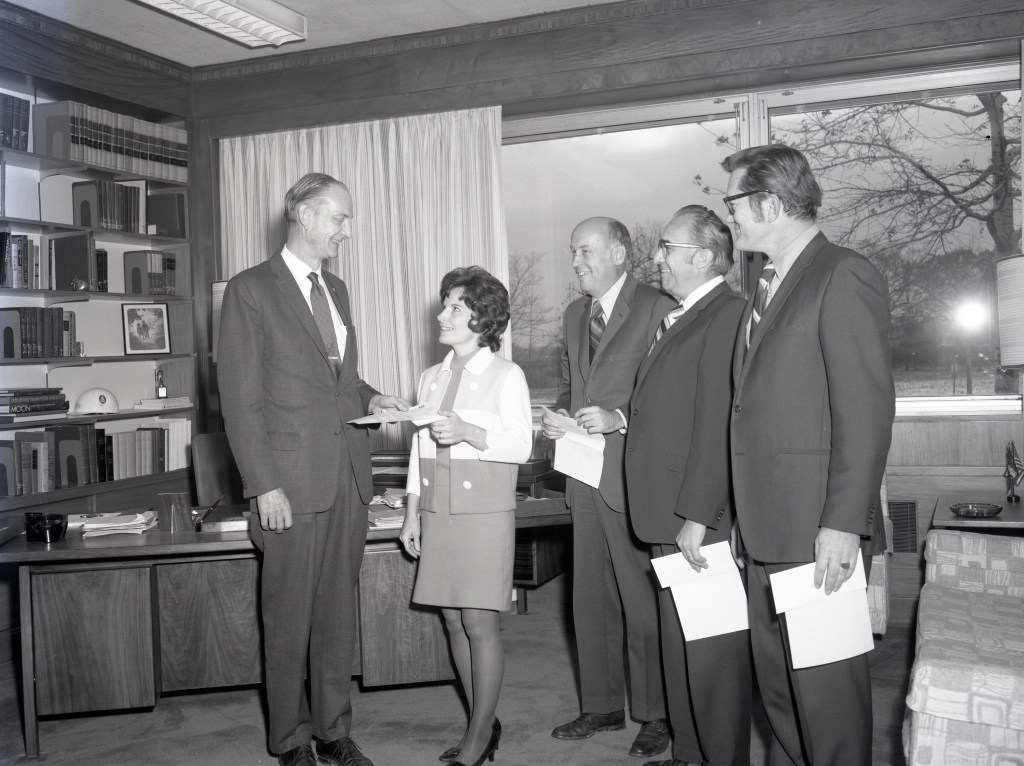 Group of people standing in office.
