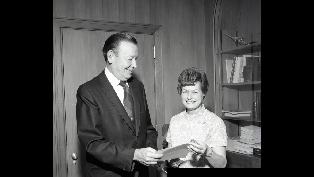 Man handing certificate to woman.