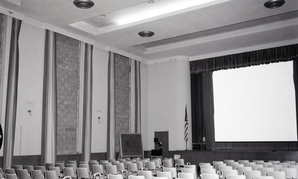 Empty auditorium with bricked-up windows.