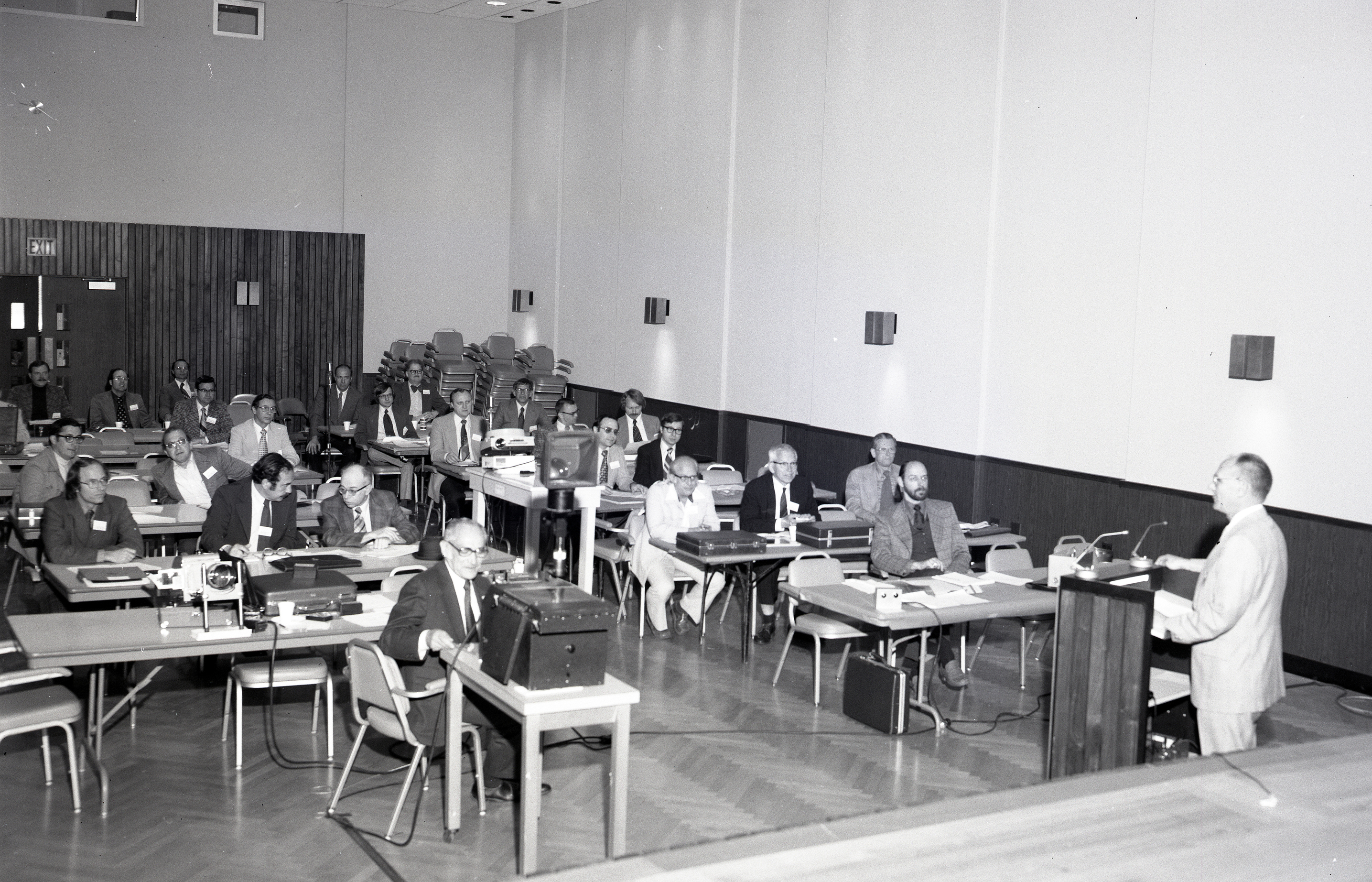 People listening to presentation in auditorium.
