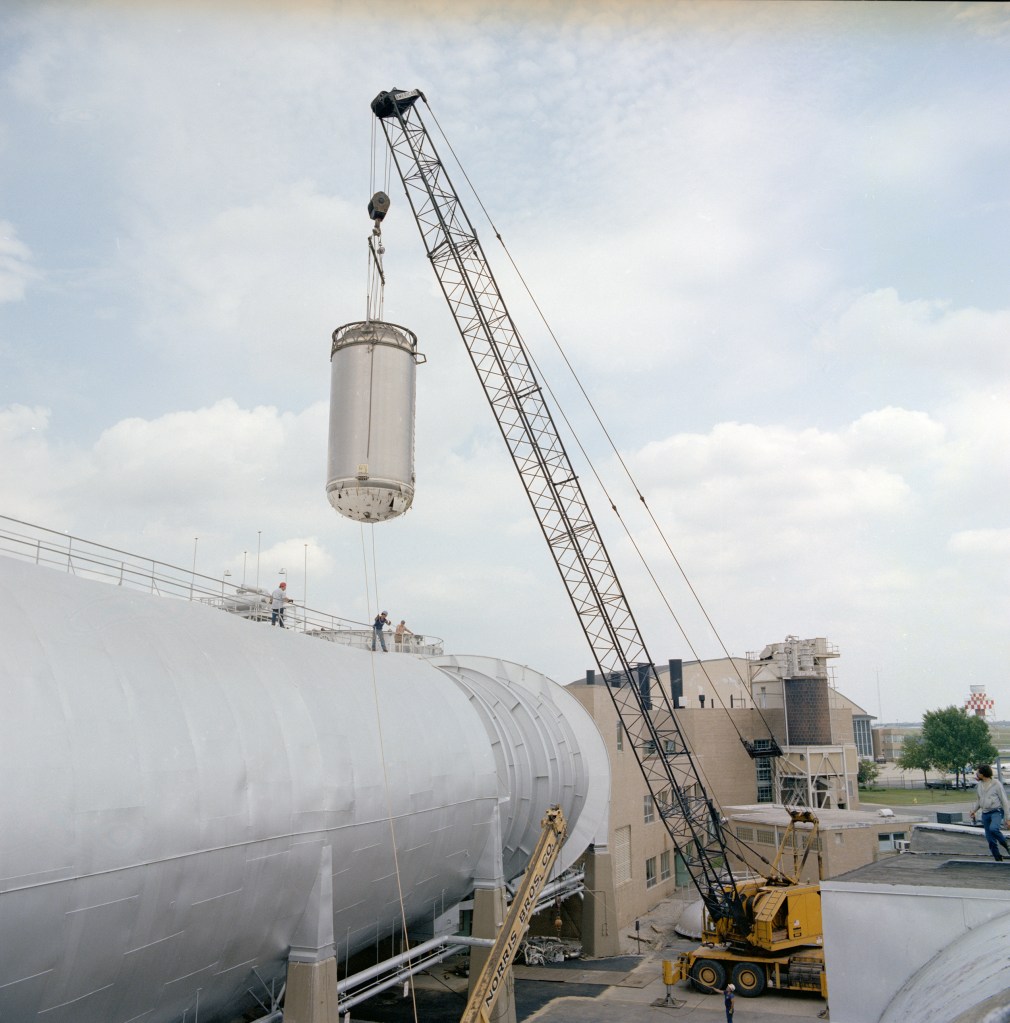 A crane lifts the Centaur stage from the SPC chamber