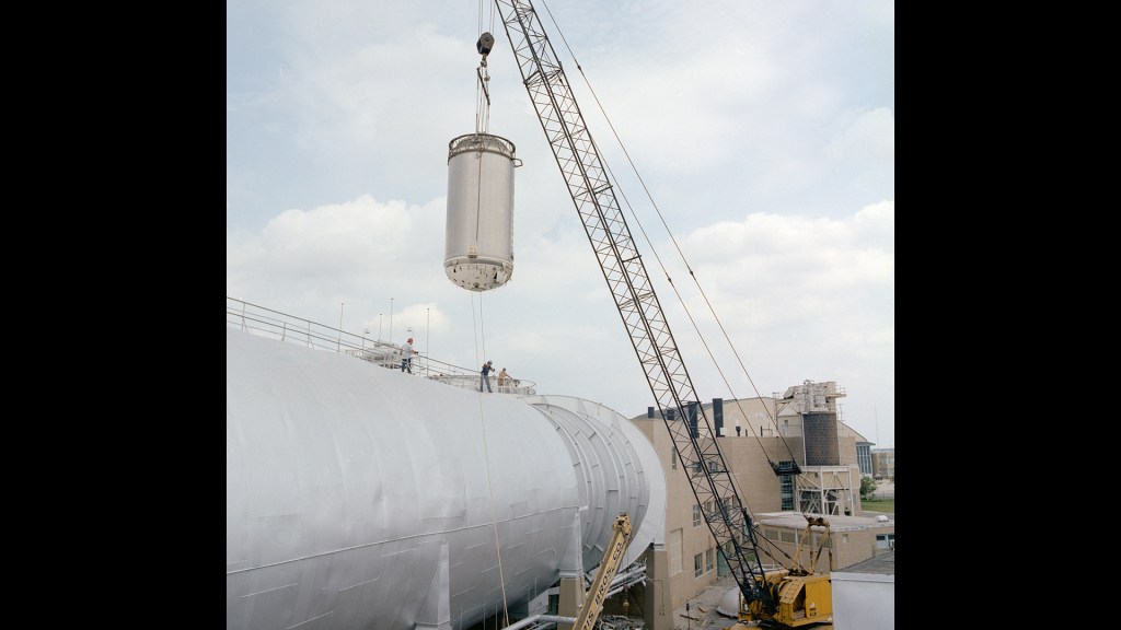 A crane lifts the Centaur stage from the SPC chamber