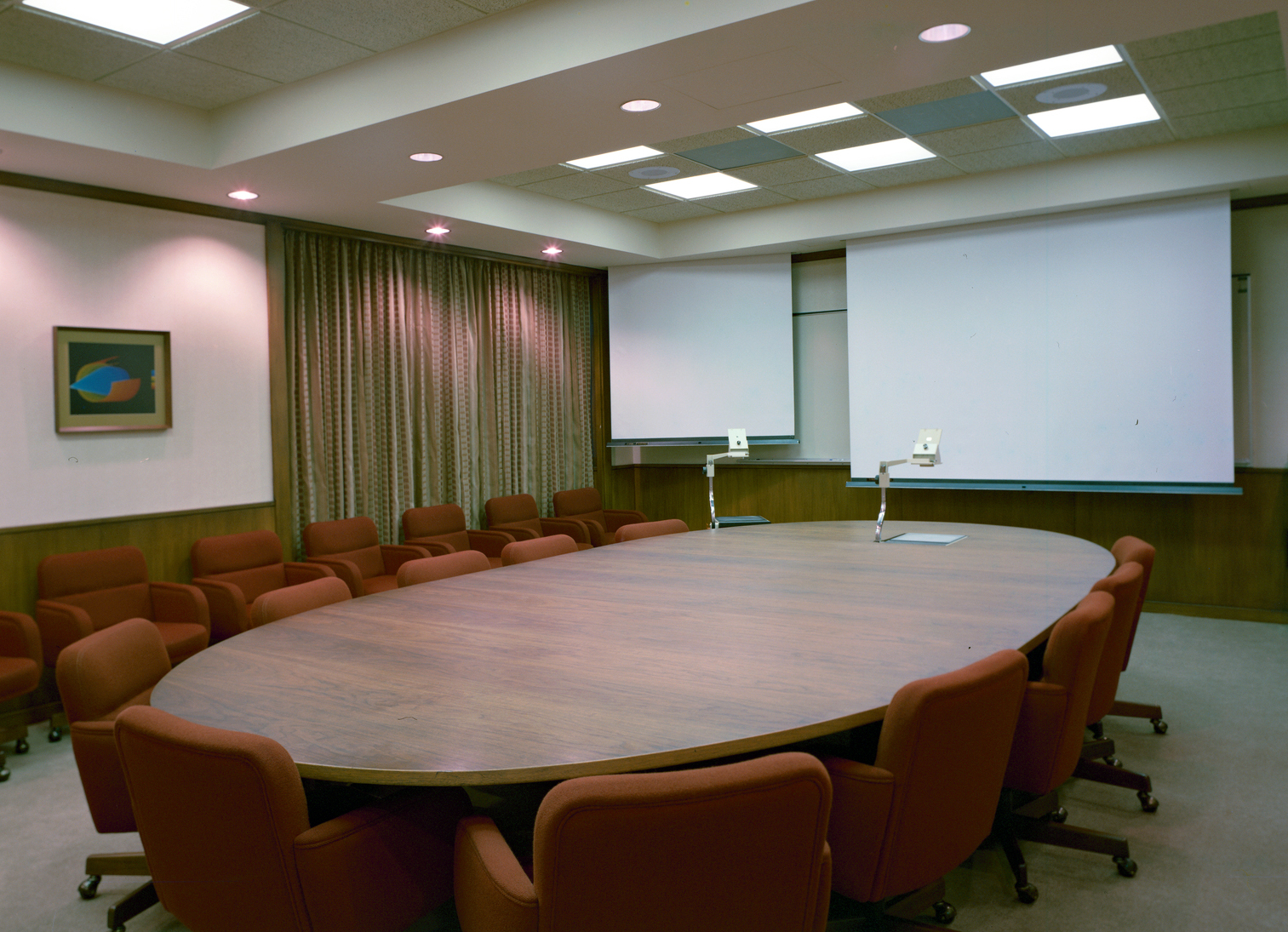 Oval table in empty conference room.