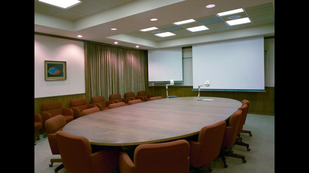 Oval table in empty conference room.