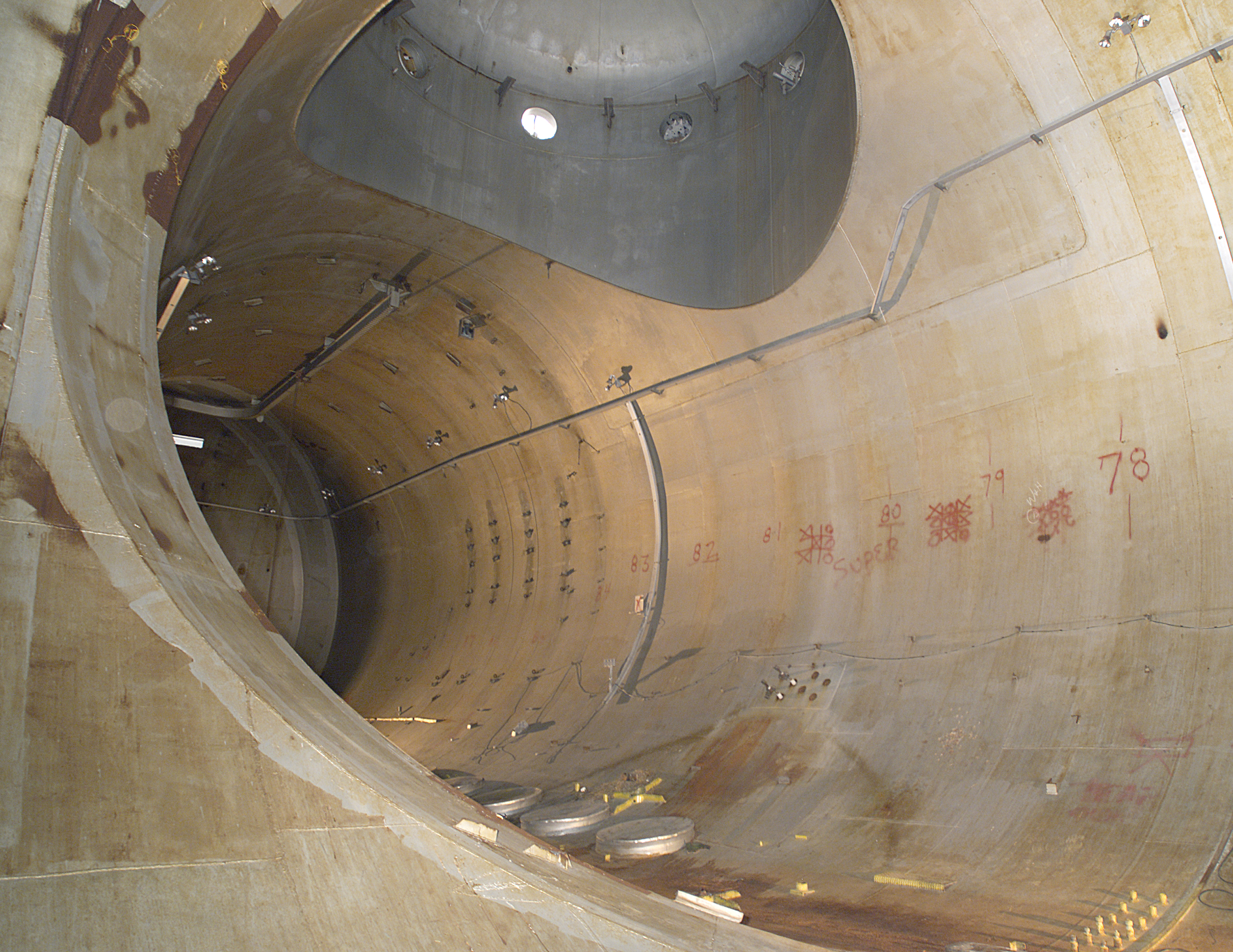 Rusting interior of large chamber.