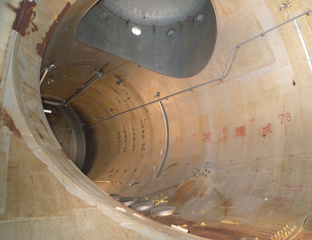 Rusting interior of large chamber.