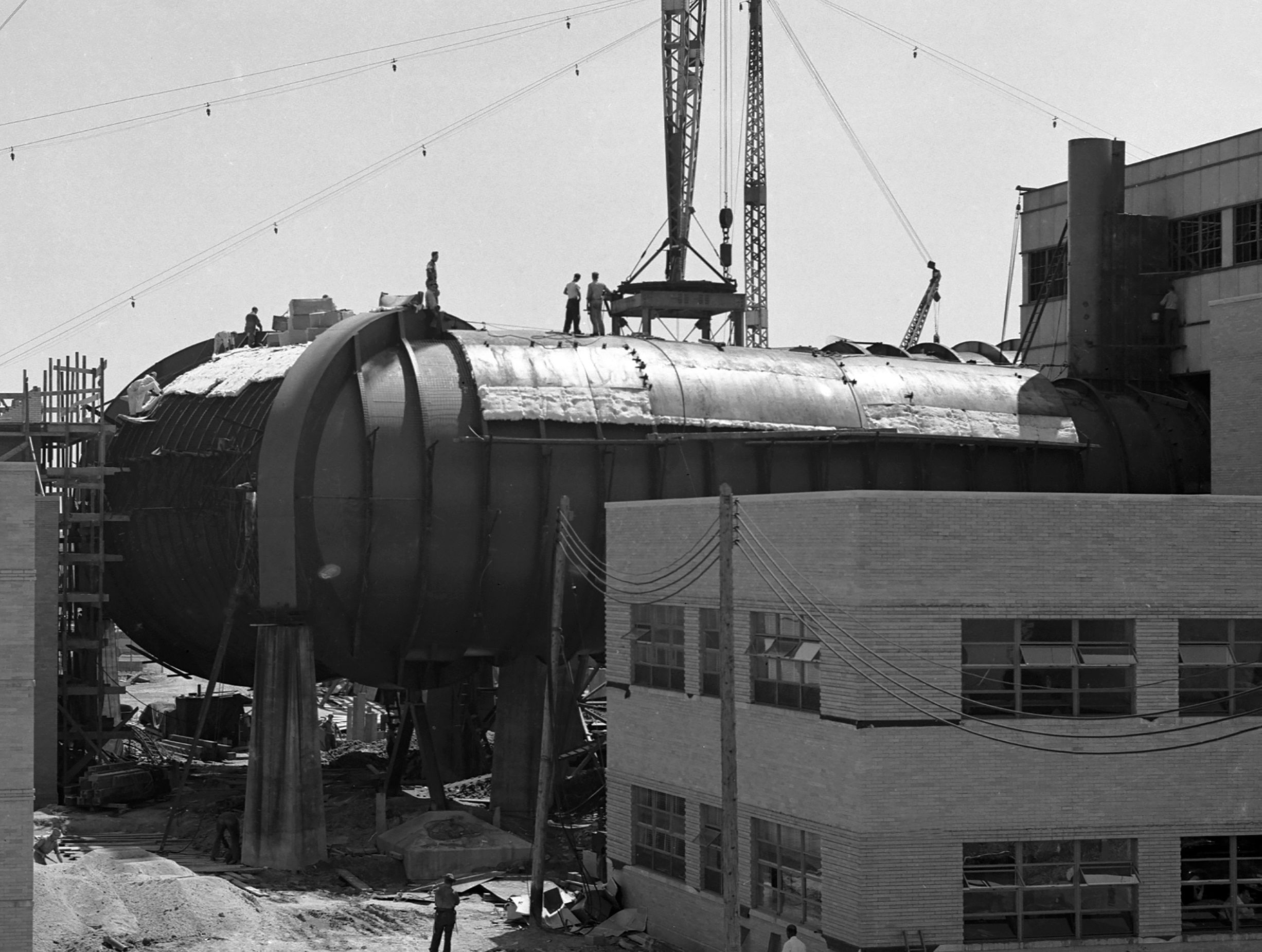 Men on top of AWT applying insulation