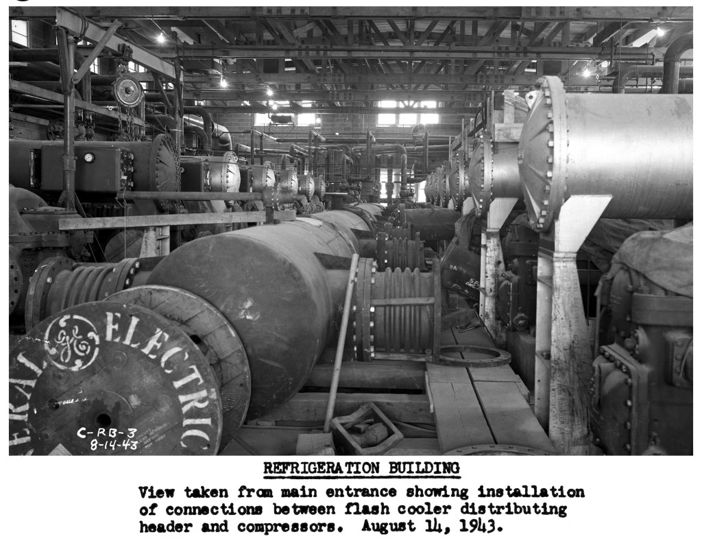 Tubular flash cooler between compressors in Refrigeration Building