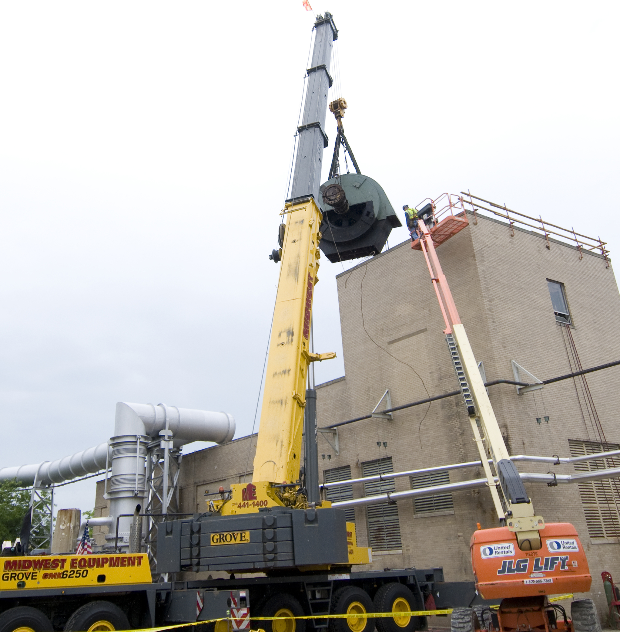 Crane lifts drive motor from roof of Exhauster Building