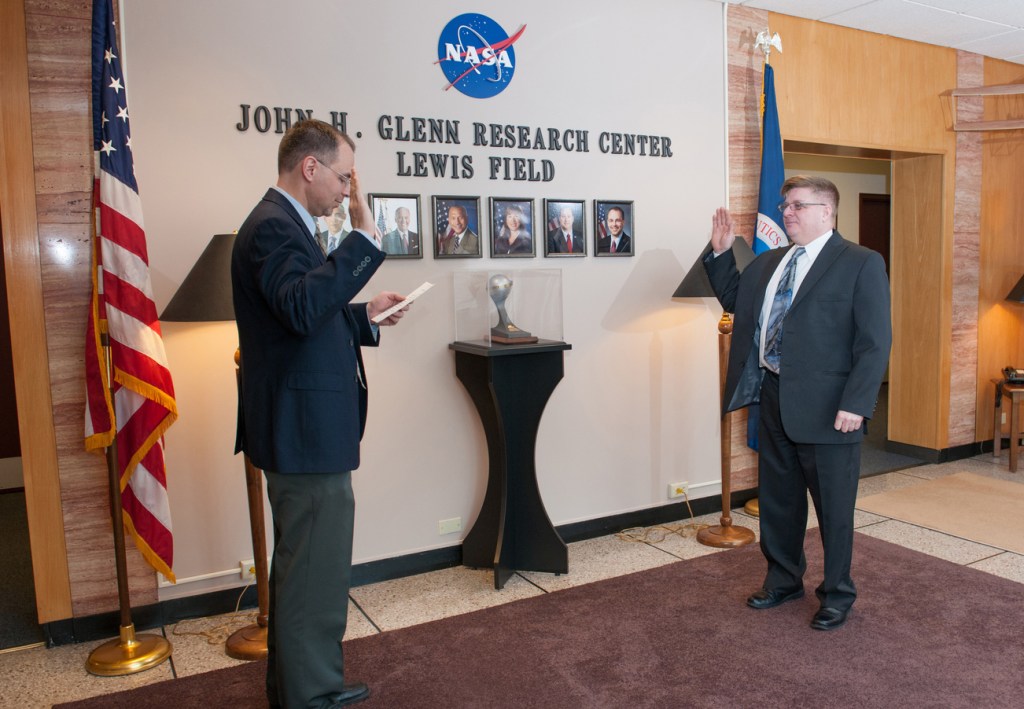 Two men in lobby giving oath.