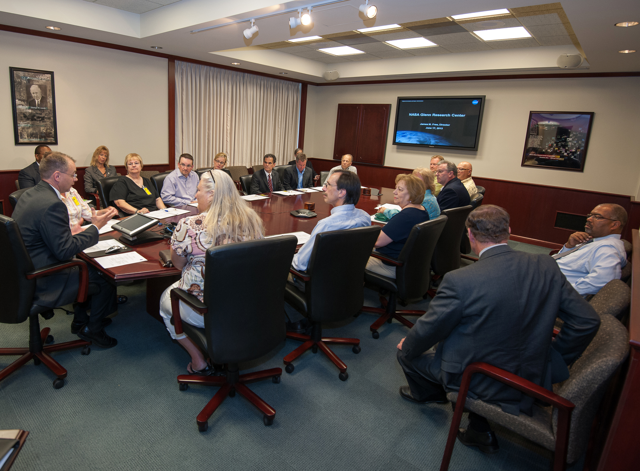 Man speaking to people in conference room.