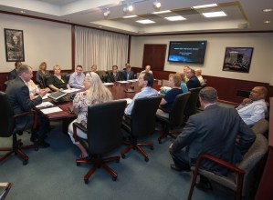Man speaking to people in conference room.