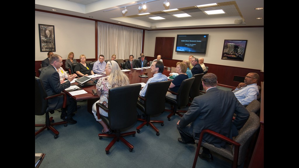 Man speaking to people in conference room.