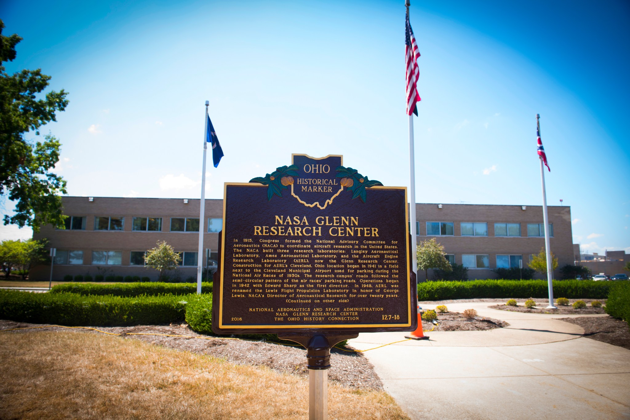 Historical marker with building behind.
