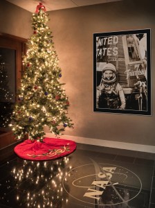 Christmas tree next to John Glenn poster.