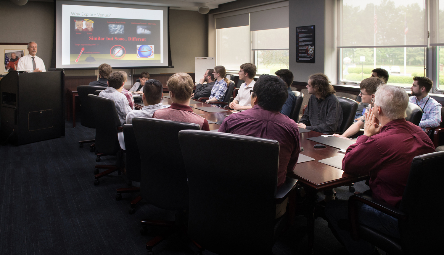 Group watching screen in conference room.