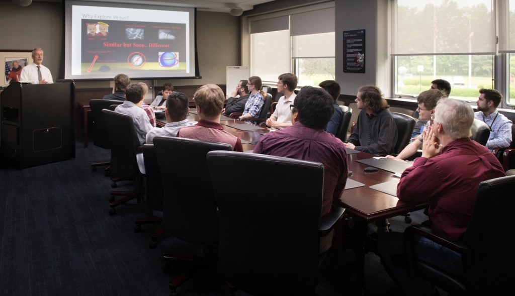 Group watching screen in conference room.