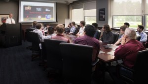 Group watching screen in conference room.