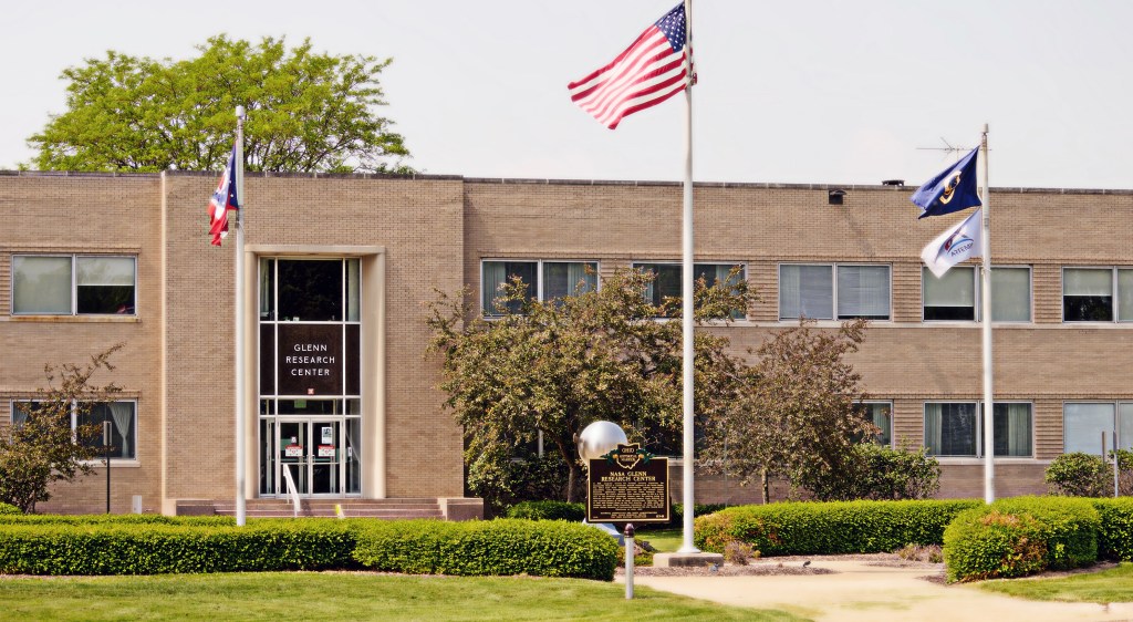 Flagpoles in front of building.