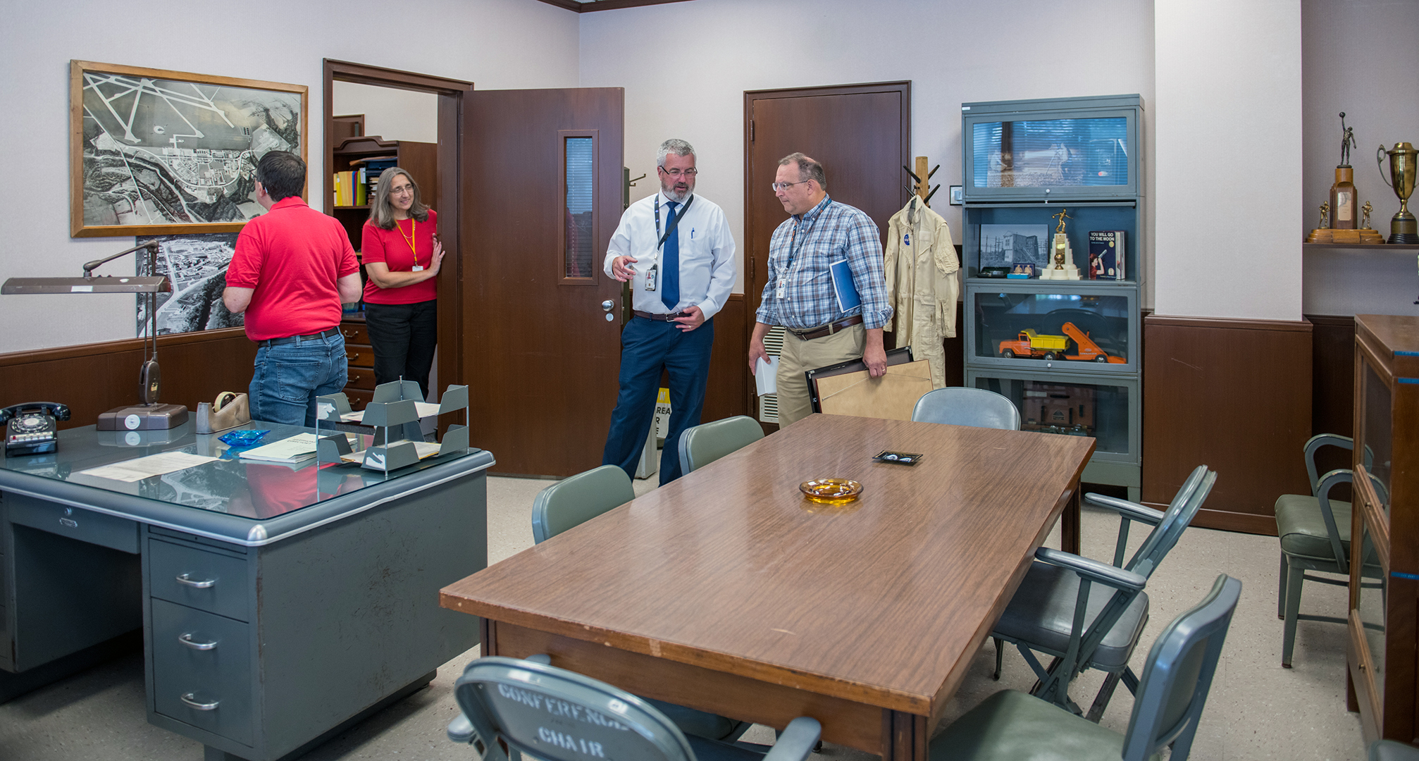 People looking at objects in room.