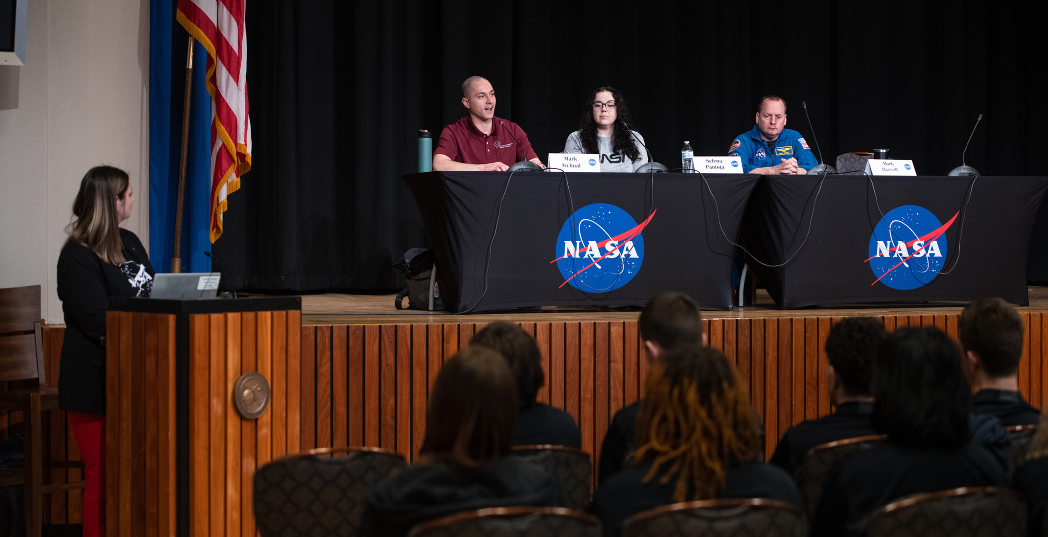 Panel of students on stage.