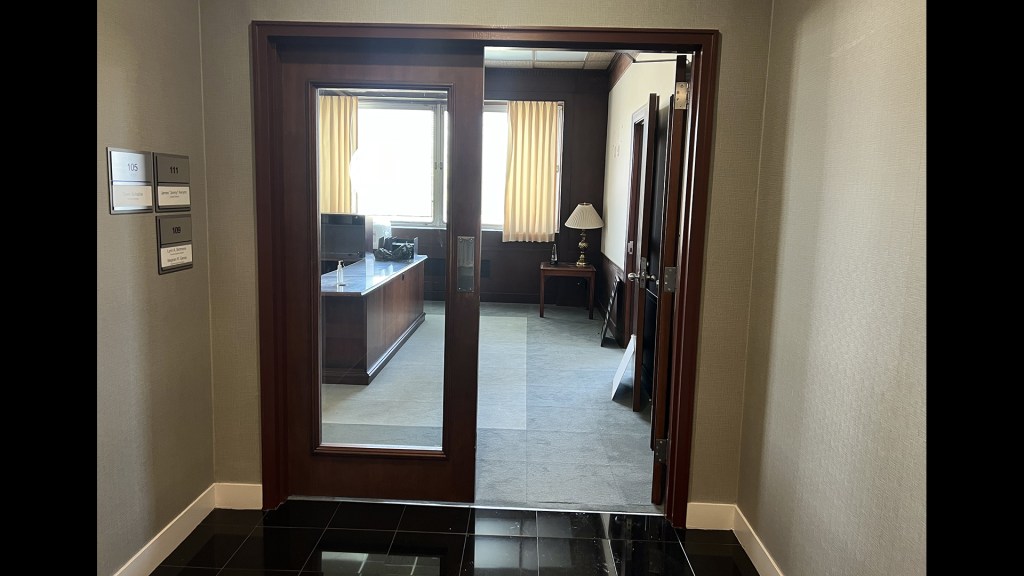 Glass doors leading into office.