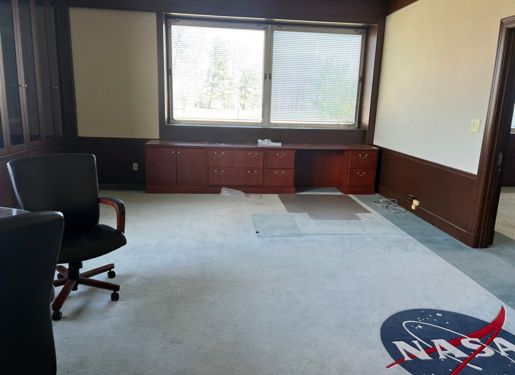 Empty office with NASA logo on carpet.