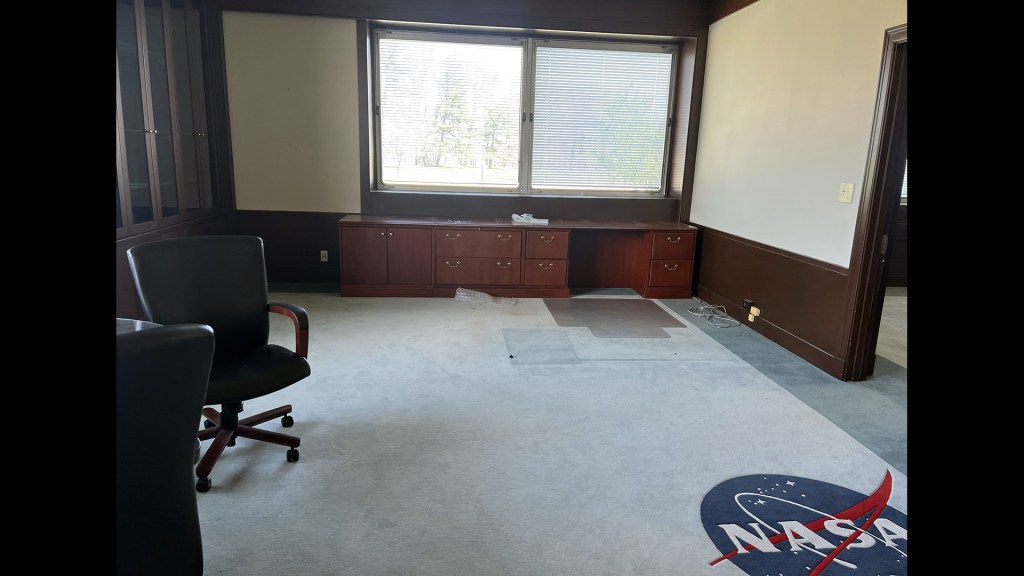 Empty office with NASA logo on carpet.