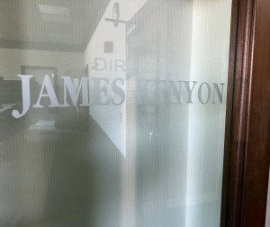 Glass door with Jimmy Kenyon etched.