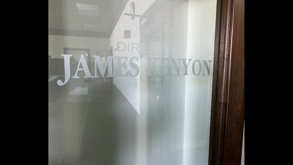Glass door with Jimmy Kenyon etched.