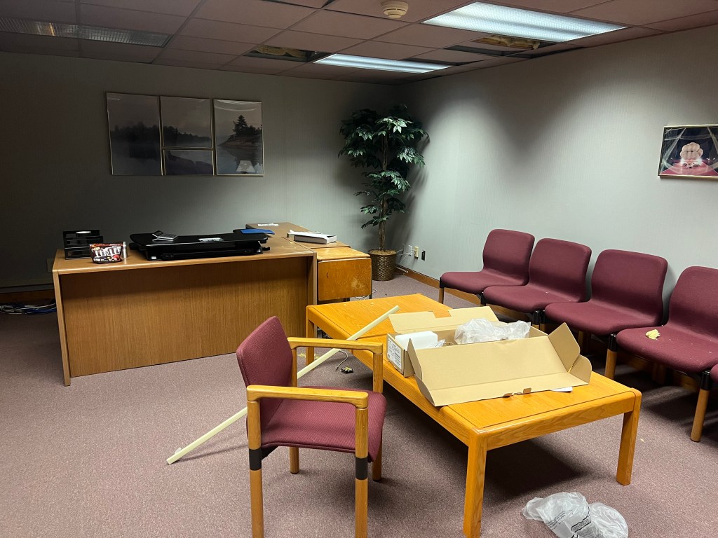 Office with desk, table, and chairs.