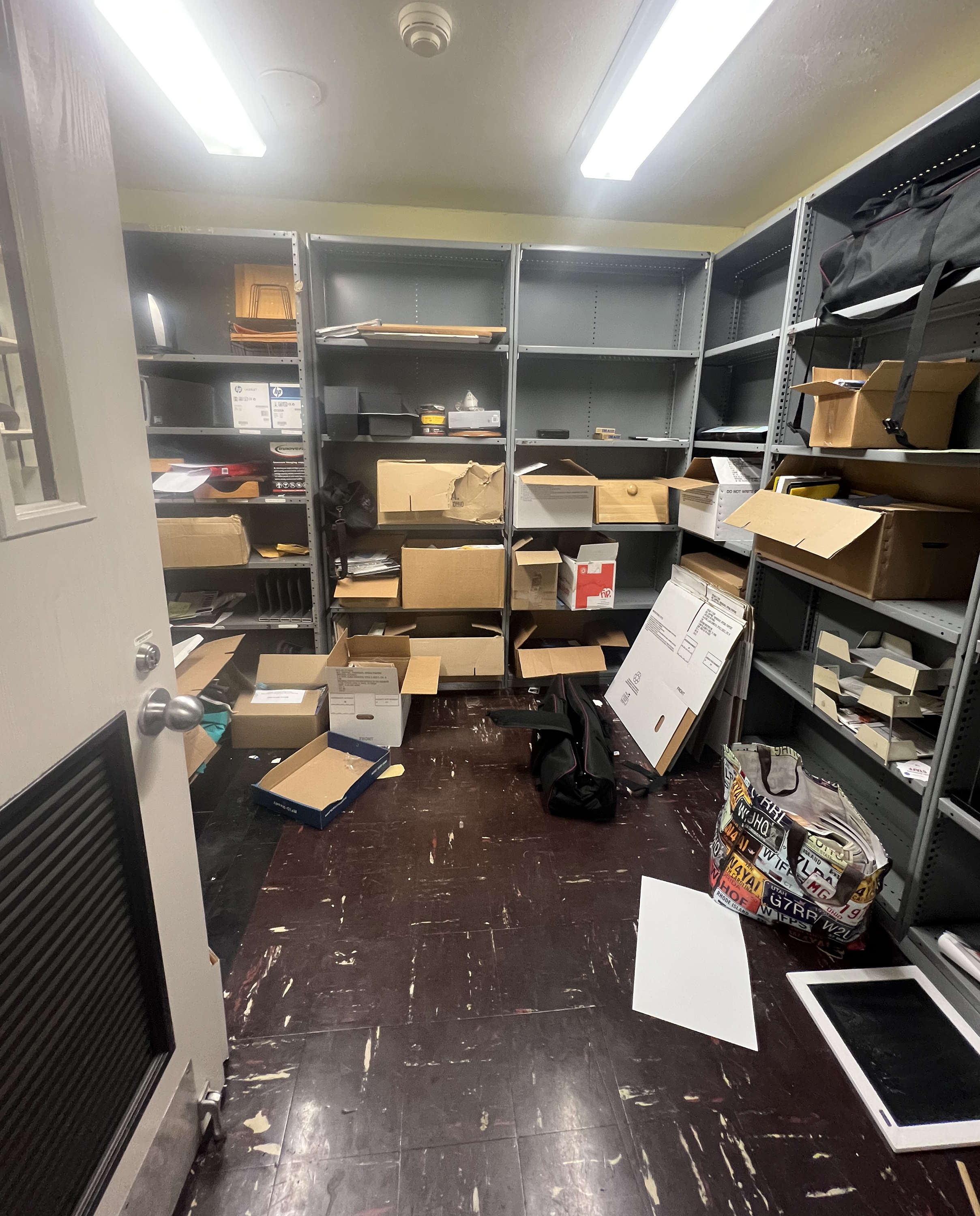Small room with shelving units.