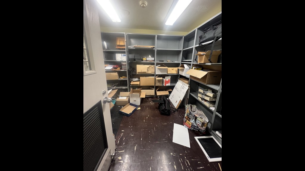 Small room with shelving units.