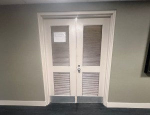 Two closed doors with vents.