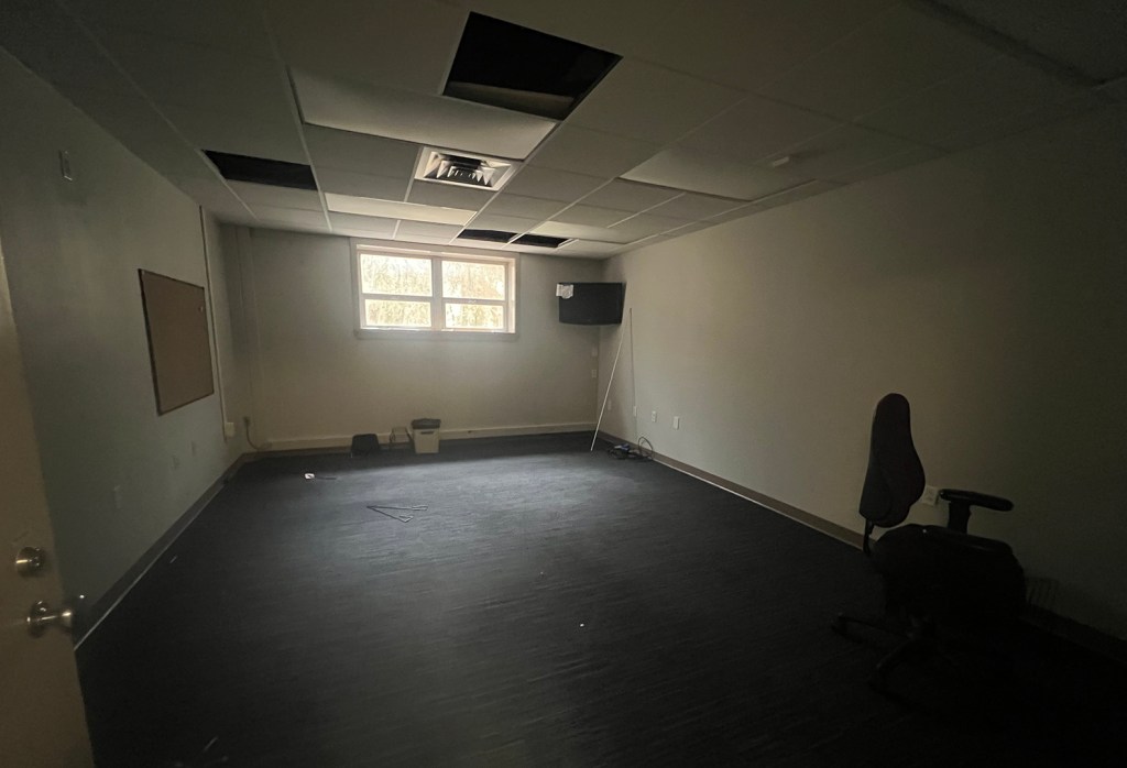 Empty basement room with light coming in window.