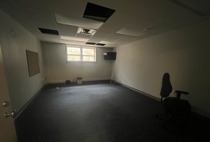 Empty basement room with light coming in window.