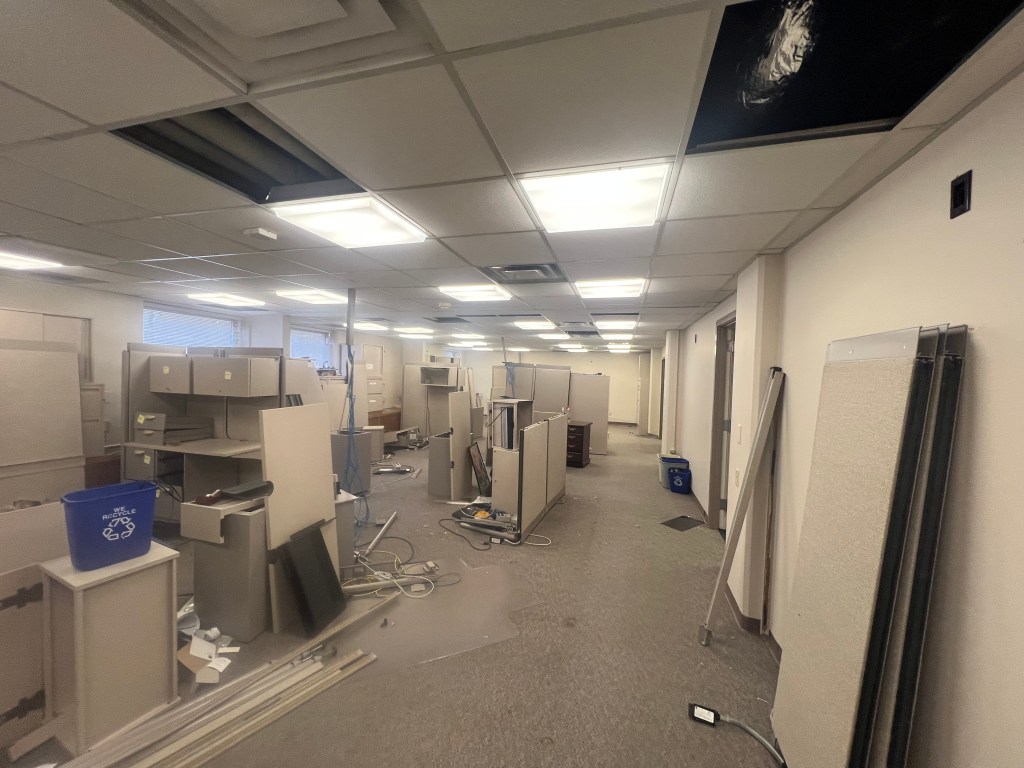 Large empty office with cubicles.