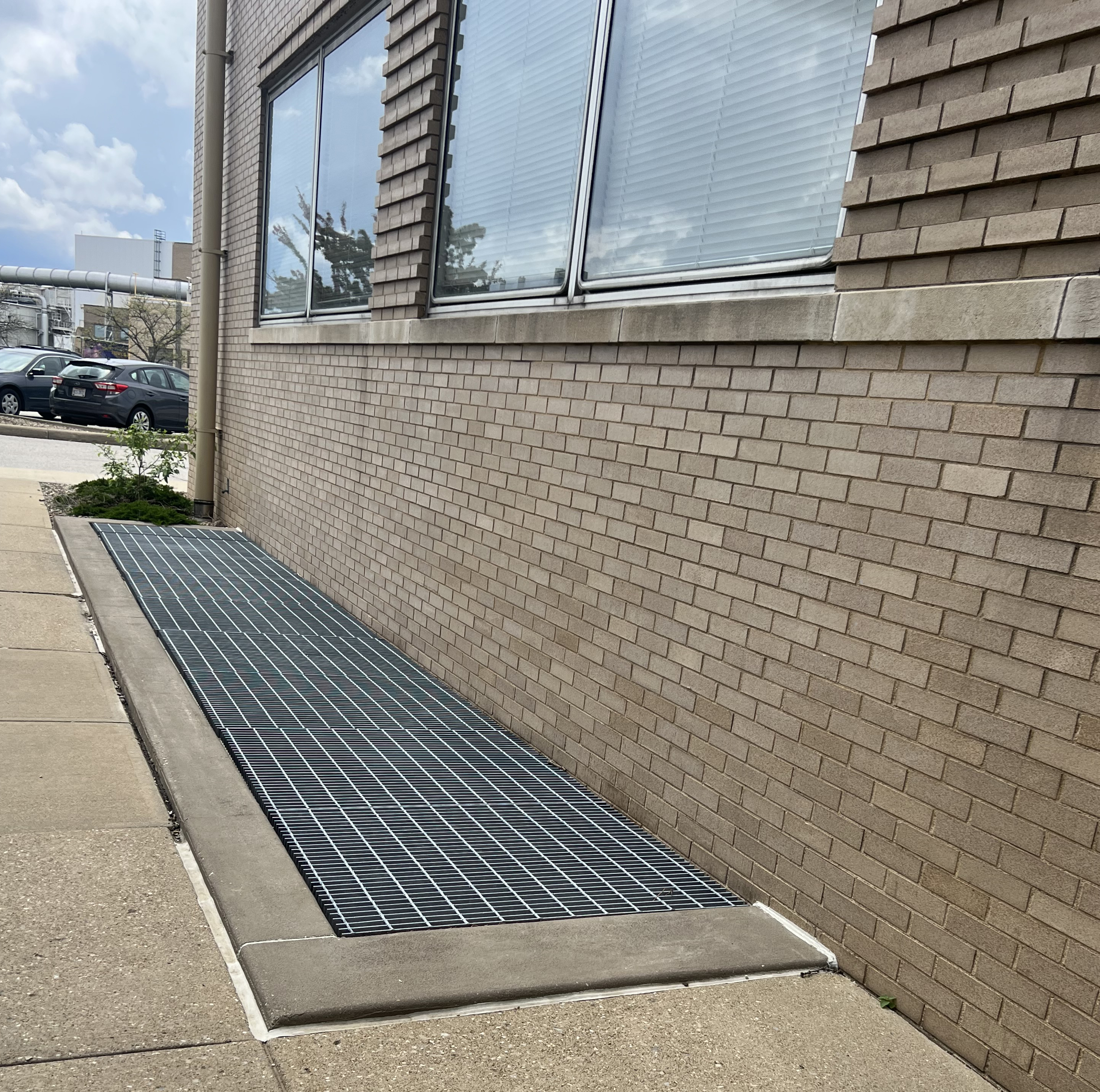 Grated area next to building.