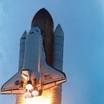 Space shuttle Atlantis roaring into the sky