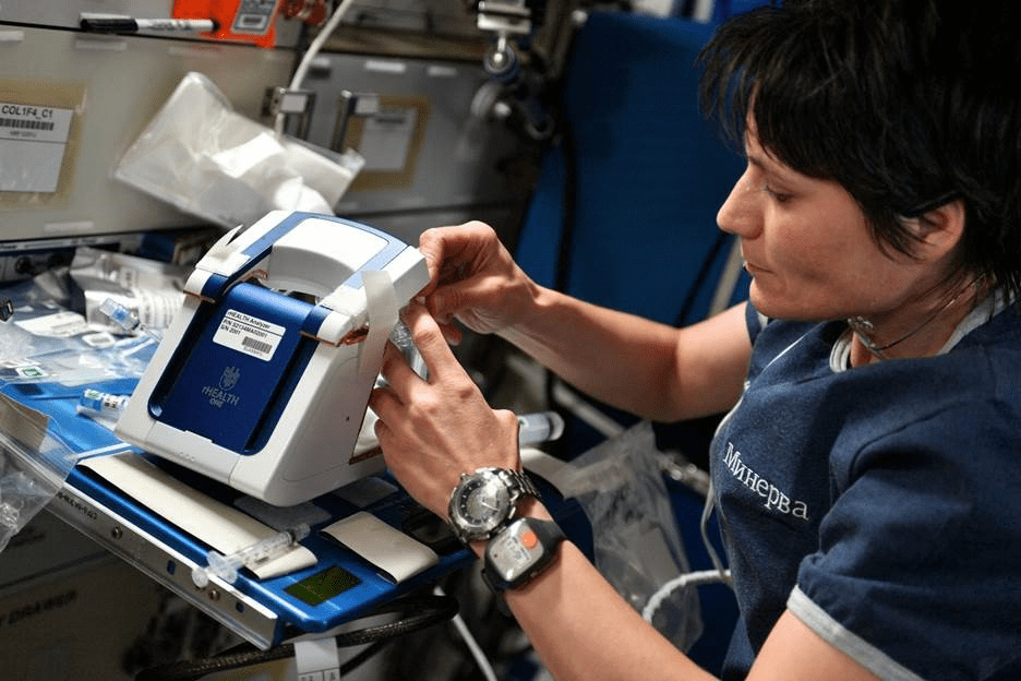 ESA astronaut operates the rHEALTH One analyzer on the International Space Station.