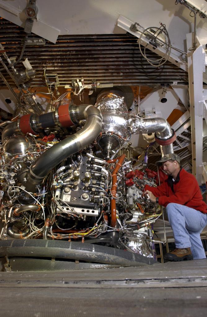 an engineer working on a space shuttle main engine